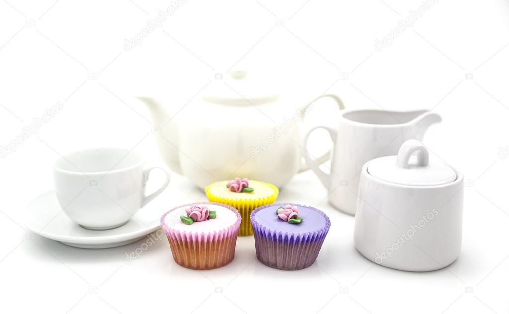 Tea party with cup cakes on white background