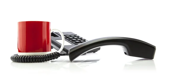 Office Concept with telephone and red mug on white background — Stock Photo, Image