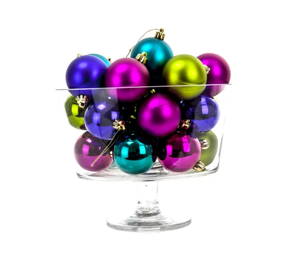 Multi-colored Christmas balls in a glass isolated on white — Stock Photo, Image