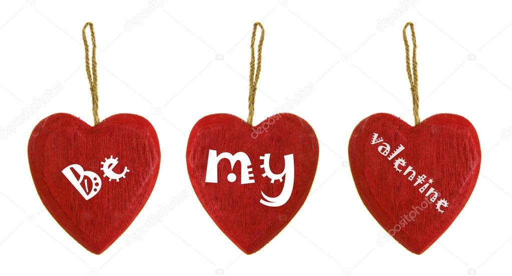 Be my Valentine three wooden Hearts on a white background