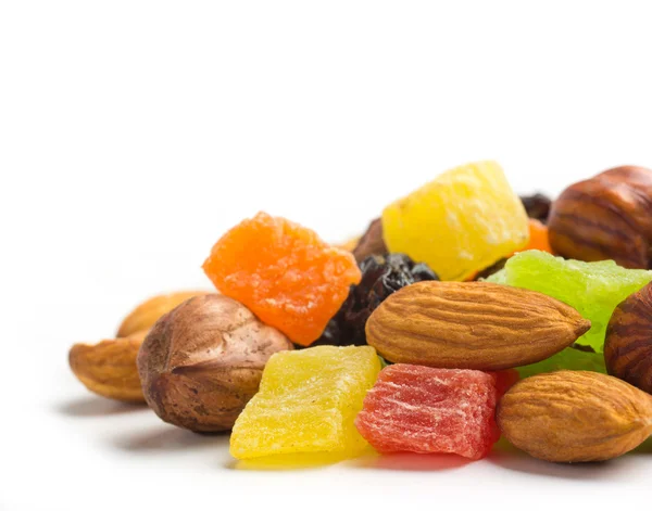 Ovoce a ořechy jako roh pozadí — Stock fotografie