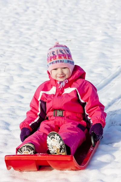 Little girl with bob in snow — Stock Photo, Image