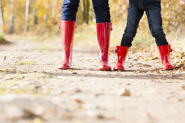 Detail of mother and daughter wearing rubber boots — Stock Photo, Image