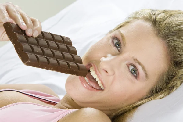 Portrait of lying woman with chocolate — Stock Photo, Image