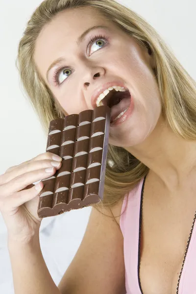 Portrait of lying woman with chocolate — Stock Photo, Image