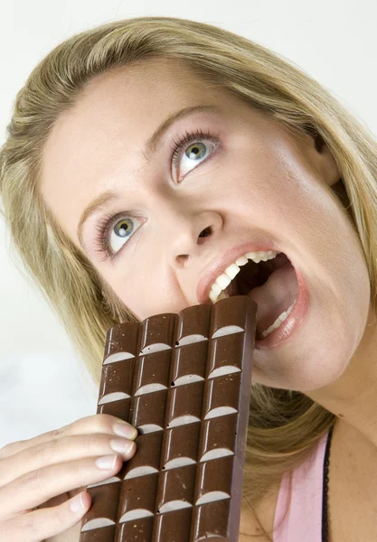 Portrait of lying woman with chocolate — Stock Photo, Image