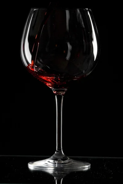 Decanter with red wine and glass on a old stone background — Stock Photo, Image