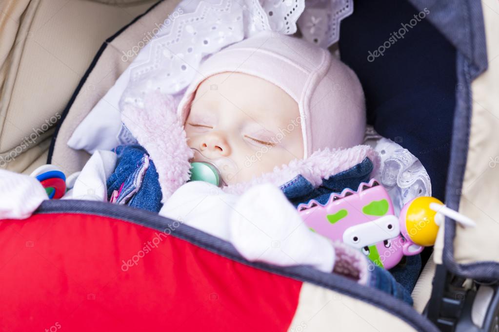 Portrait of sleeping baby girl in pram
