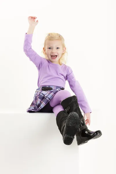 Sitting little girl wearing a skirt — Stock Photo, Image