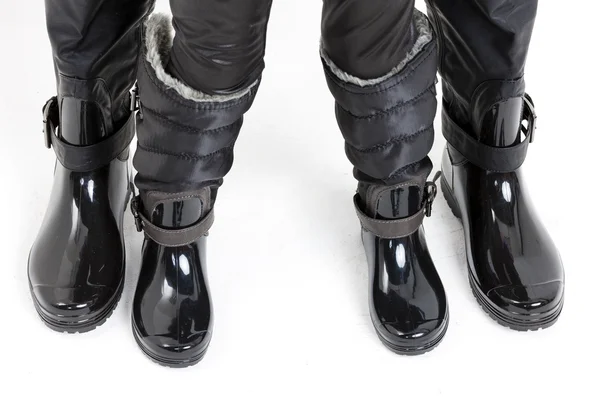 Detail of mother and daughter wearing black boots — Stock Photo, Image