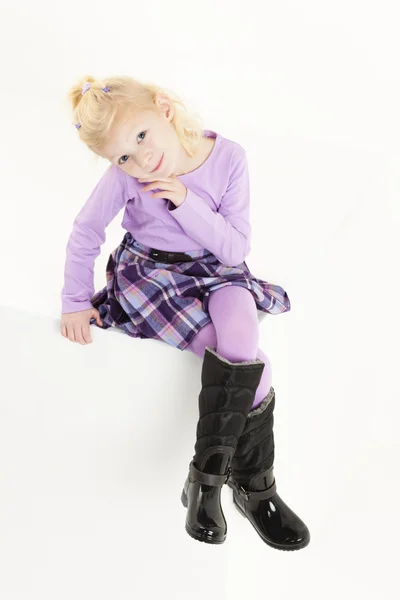 Sitting little girl wearing a skirt — Stock Photo, Image