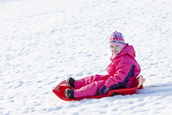 Little girl with bob in snow — Stock Photo, Image