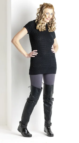 Standing woman wearing black clothes and black boots — Stock Photo, Image