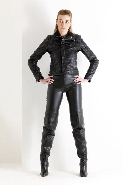 Standing woman wearing black clothes and black boots — Stock Photo, Image