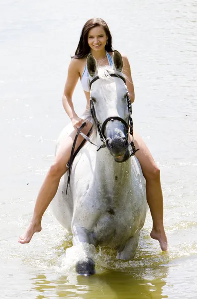 Equestrian on horseback riding through water — Stock Photo, Image