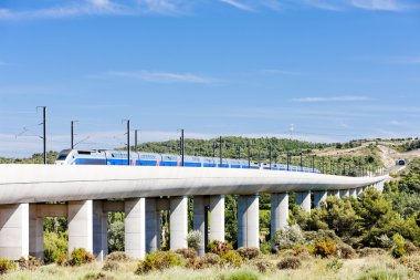 train of TGV on railway viaduct near Vernegues, Provence, France clipart