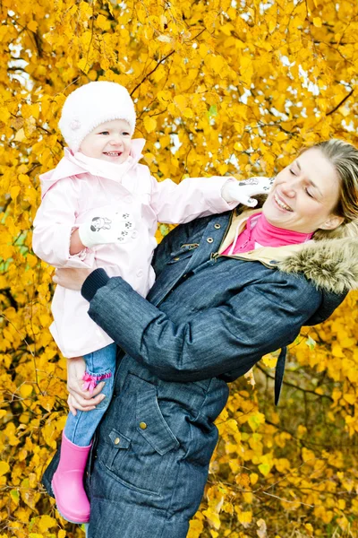 Portrait of woman with toddler in autumnal nature — Stock Photo, Image