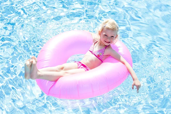 Menina com anel de borracha na piscina — Fotografia de Stock