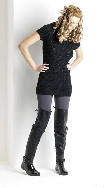 Standing woman wearing black clothes and black boots — Stock Photo, Image