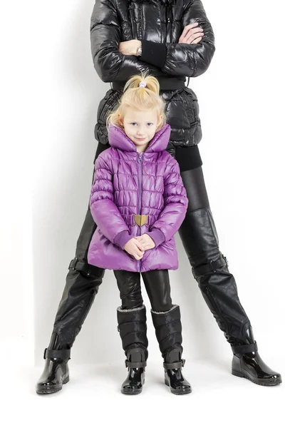 Mother and daughter wearing jackets and black boots — Stock Photo, Image