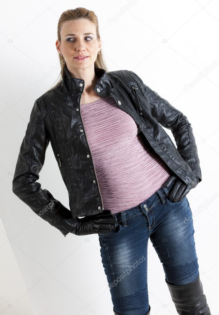 portrait of standing woman wearing jeans