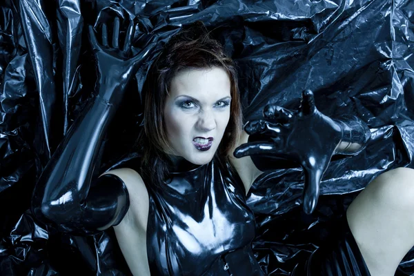 Portrait of sitting woman wearing latex clothes — Stock Photo, Image
