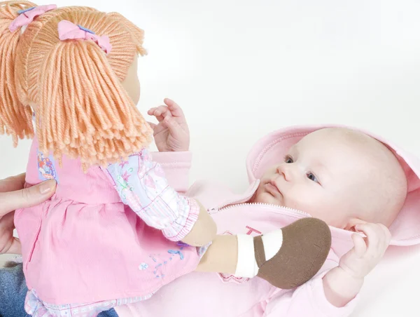 Deitado bebê menina com uma boneca — Fotografia de Stock