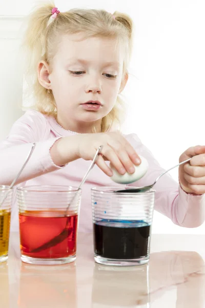 Portrait of little girl during Easter eggs' coloration — Stock Photo, Image