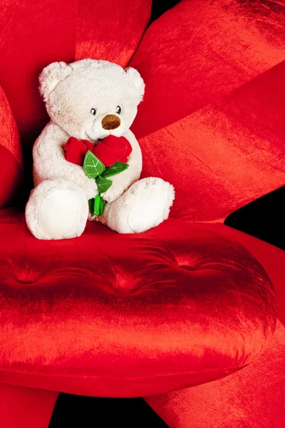 Teddy bear on red armchair — Stock Photo, Image