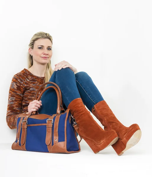 Sitting woman wearing fashionable platform brown shoes with a ha — Stock Photo, Image