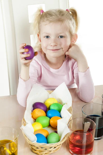 Portrait of little girl during Easter eggs' coloration — Stock Photo, Image