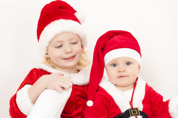 Two little girls as Santa Clauses Stock Image
