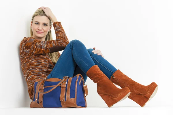 Sitting woman wearing fashionable platform brown shoes with a ha — Stock Photo, Image