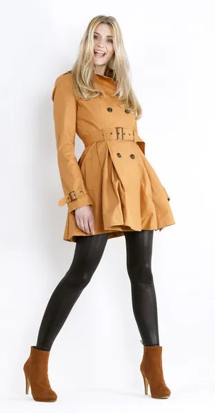 Standing woman wearing coat and fashionable brown shoes — Stock Photo, Image