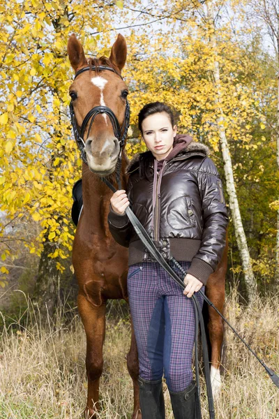 Equestrian with her horse in autumn — Stock Photo, Image