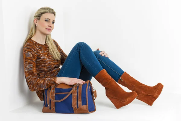 Sitting woman wearing fashionable platform brown shoes with a ha — Stock Photo, Image