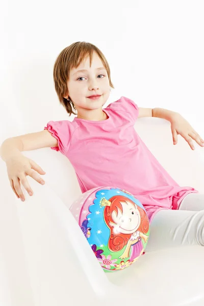 Portrait of girl sitting with a ball — Stock Photo, Image