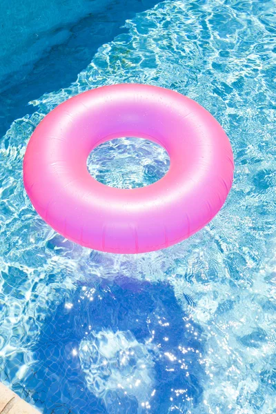 Pink rubber ring in swimming pool — Stock Photo, Image