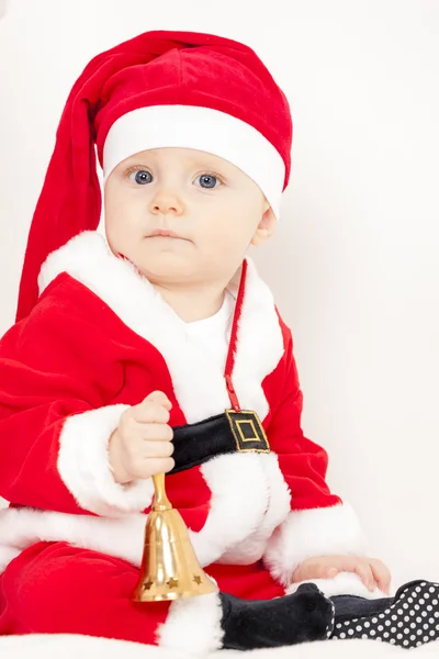 Маленькая девочка, как Санта Клаус с колокольчиком — стоковое фото