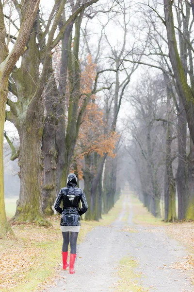 Woman in autumnal alley — Stock Photo, Image