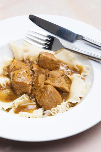 Pork pieces on cumin with pasta — Stock Photo, Image