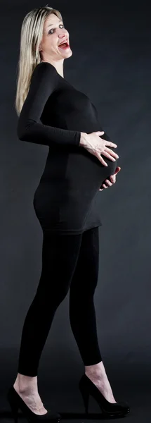 Беременная женщина в черной одежде и насосах — стоковое фото
