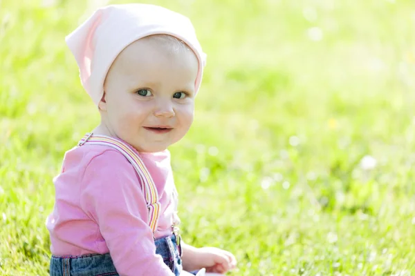 Portrait of toddler girl sitting on lawn Royalty Free Stock Photos