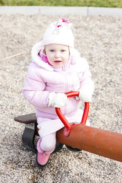 Little girl sitting on swing — Stock Photo, Image