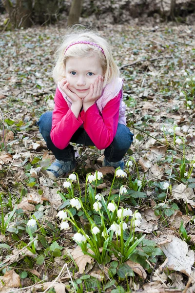 Meisje met sneeuwvlokken in de lente natuur — Stockfoto