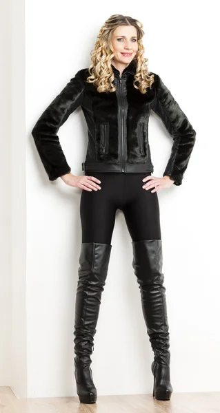 Standing woman wearing fashionable black clothes and boots — Stock Photo, Image