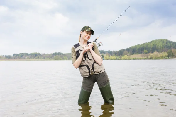 Woman fishing in pond in spring — Stock Photo, Image