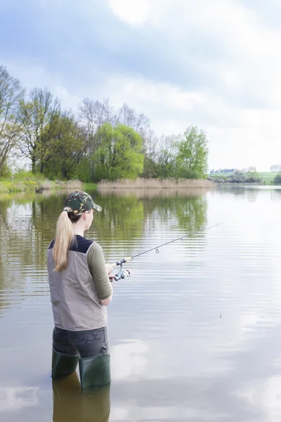 Woman fishing in pond in spring — Stock Photo, Image