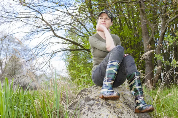 Woman wearing rubber boots in spring nature — Stock Photo, Image