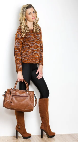 Standing woman wearing fashionable brown boots with a handbag — Stock Photo, Image